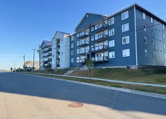 A street view of a residential area with apartment buildings.
