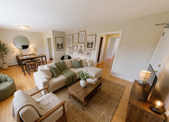 A living room with a green bean bag chair and a white couch.