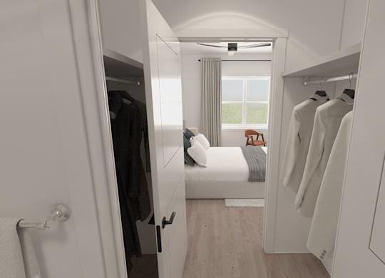 A white room with a bed and a wardrobe.
