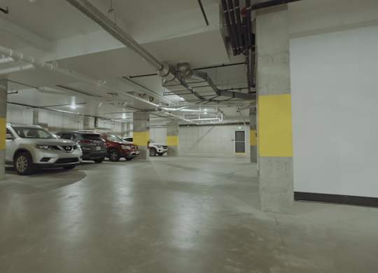 A parking garage with cars parked in it.