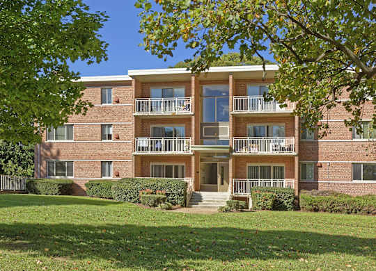 A large brick building with a balcony on the second floor.