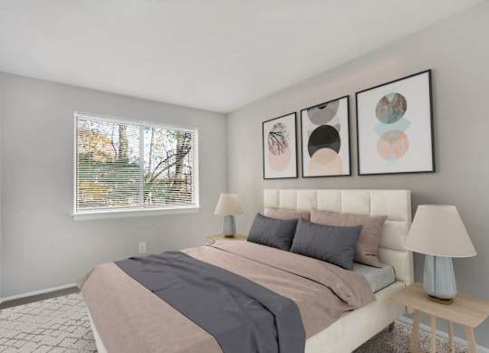 A bedroom with a large bed and three framed pictures on the wall.