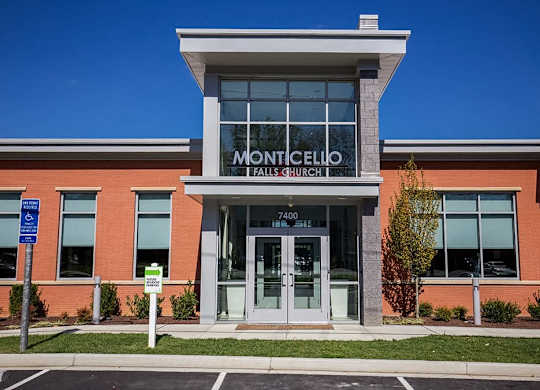 The Monticello Falls Church building has a large glass window.