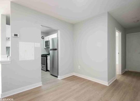 A kitchen with a refrigerator, oven, and microwave.