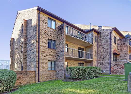 A large brick building with a balcony on the second floor.