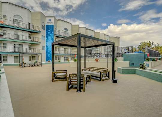 A patio area with a table and chairs under a canopy.