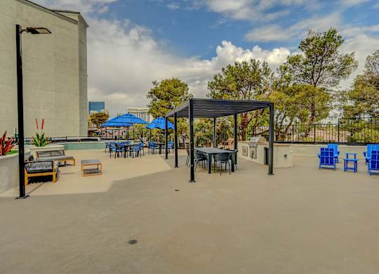 A patio area with blue chairs and tables.