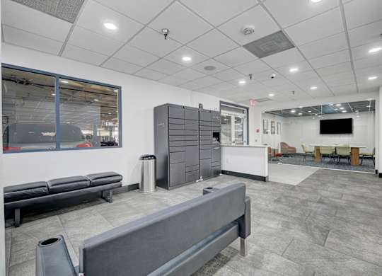 A room with a grey floor and a grey bench.