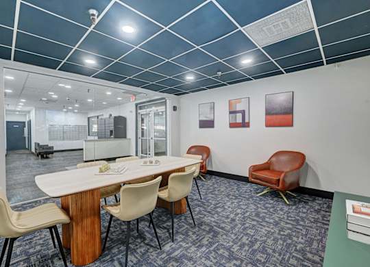 A conference room with a long table and chairs.