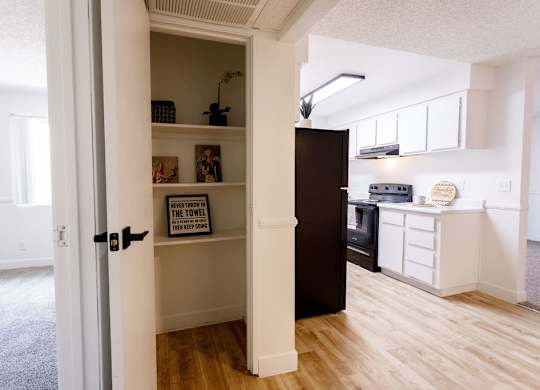 A kitchen with a towel hanging on the oven.
