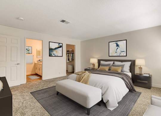 A bedroom with a large bed and a painting on the wall.