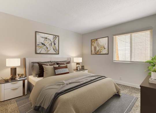 A bedroom with a large bed and two lamps on either side of it.