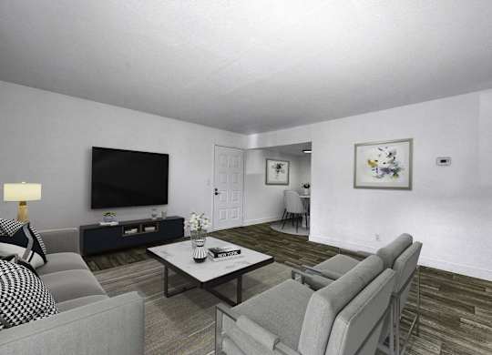 A living room with a grey couch, a black and white sofa, a coffee table, and a television.