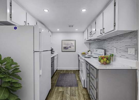 A modern kitchen with white cabinets and a wooden floor.
