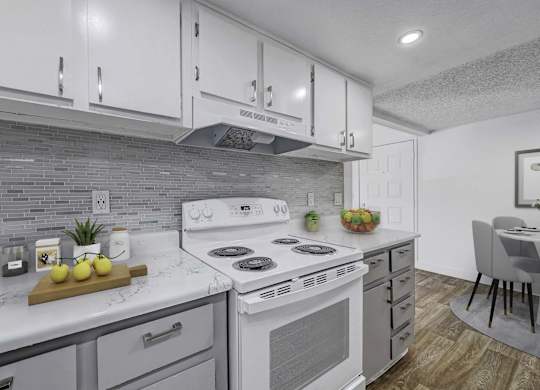 A modern kitchen with a white stove top oven and a wooden cutting board with lemons on it.