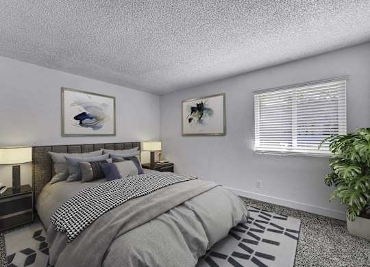 A bedroom with a large bed and a potted plant.