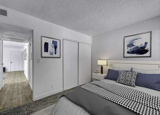 A bedroom with a large bed and two framed pictures on the wall.