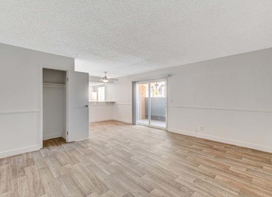 A room with wooden flooring and white walls.