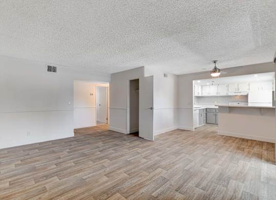 A room with a wooden floor and white walls.