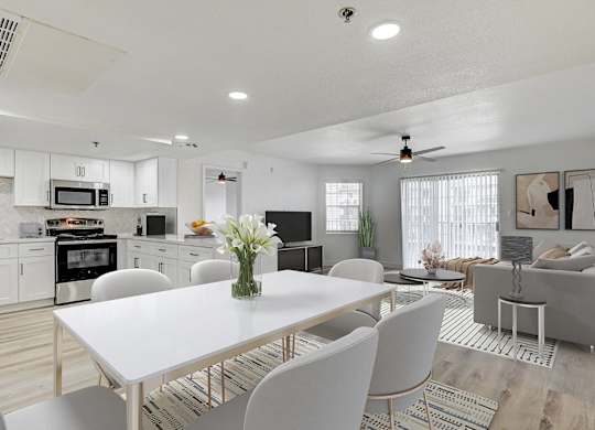 A modern kitchen with a dining table set for four.