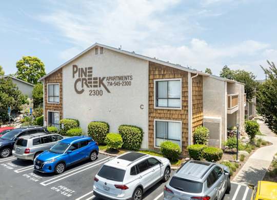 A parking lot in front of Pine Creek Apartments.