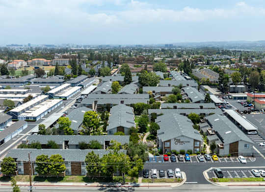 A parking lot with cars and a building with a sign that says