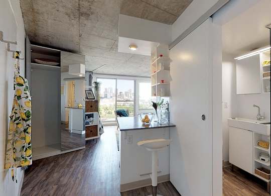 A bathroom with a white sink and a window.