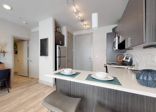 A modern kitchen with a dining table and chairs.