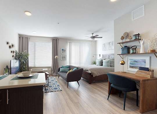 A well-lit, modern kitchen with dark wood cabinets and a white countertop.