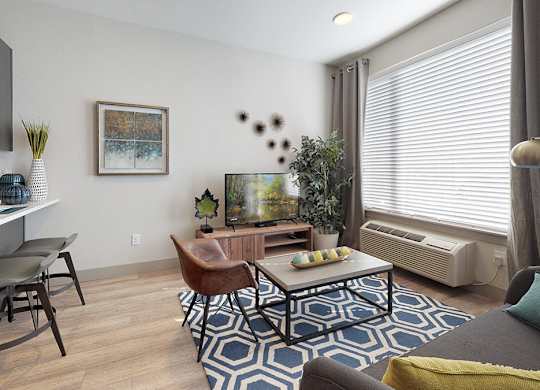 A living room with a brown leather chair and a blue and white rug.