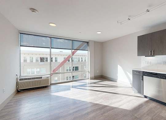A modern kitchen with a large window overlooking a cityscape.