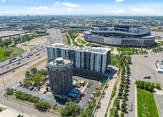 A large stadium is surrounded by buildings and roads.