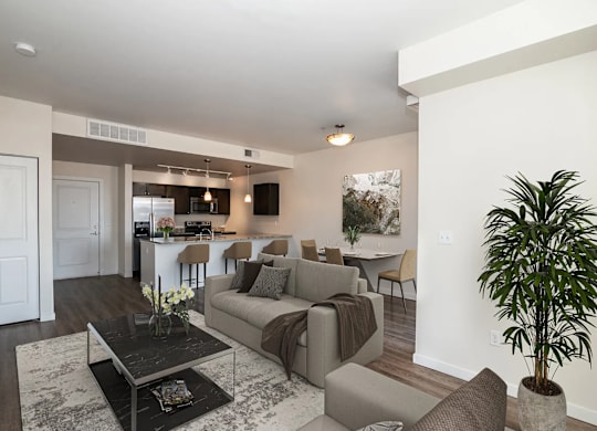 A living room with a couch, chairs, and a coffee table.