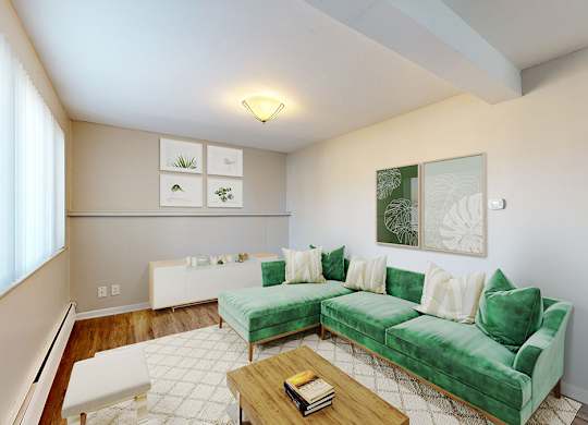 A living room with a green couch and a coffee table.