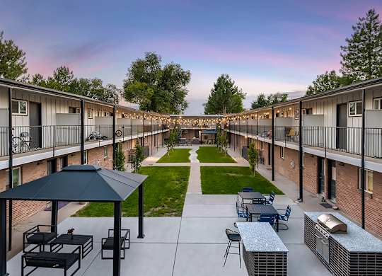 A sunny day at the outdoor seating area of a residential complex.