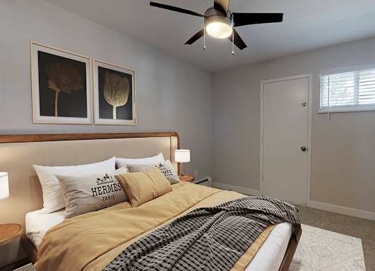 A bedroom with a bed, a ceiling fan, and a window.