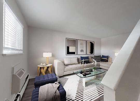 A living room with a staircase leading to the upper floor.