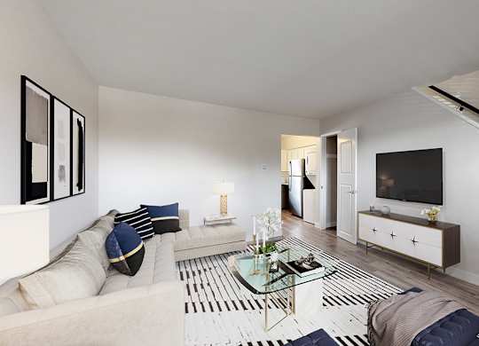 A modern living room with a glass coffee table and a white sofa.