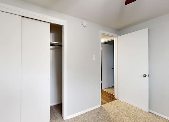 A white door is open to a hallway.