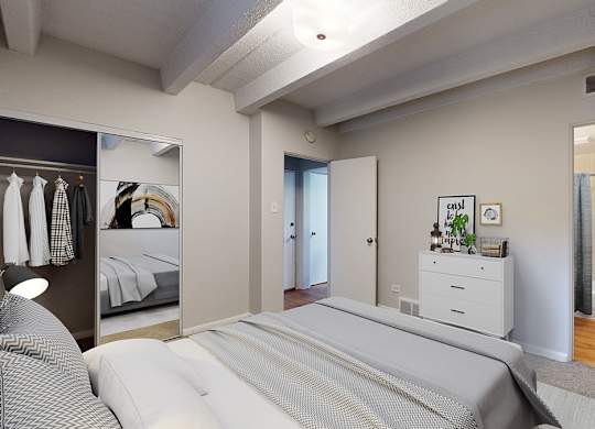 A bedroom with a large bed and a mirror on the wall.