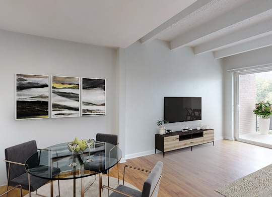 A modern dining room with a glass table and chairs.