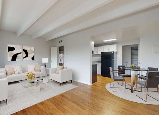 A modern living room with white furniture and a wooden floor.