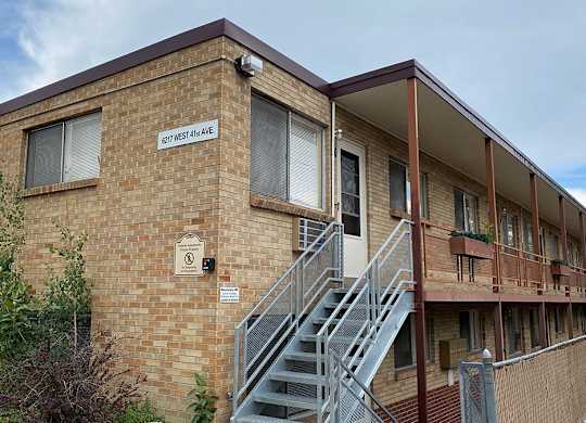A brick building with a sign that says