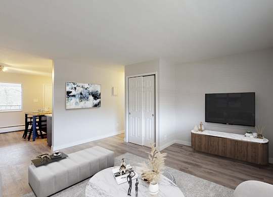 A modern living room with a grey sofa and a wooden coffee table.