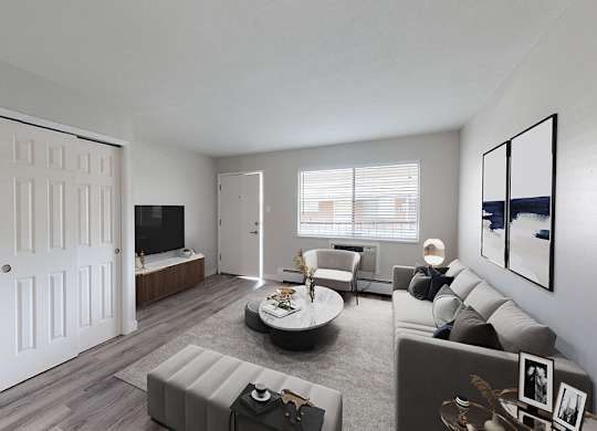 A modern living room with a grey sofa and a white door.