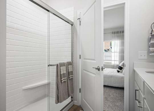 A bathroom with a white tub and a white door.