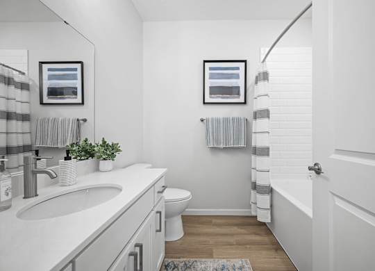 A bathroom with a white toilet and a white sink.