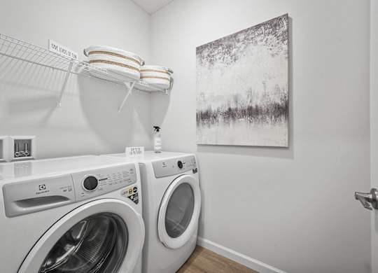 A washing machine and dryer in a laundry room.