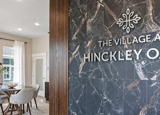 A dining room with a marble wall and a logo that says