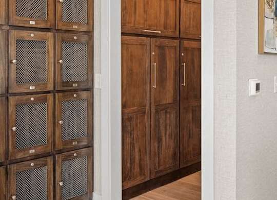 A set of wooden doors with glass panels on the left side.